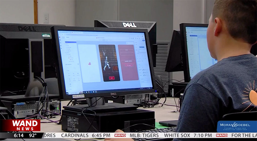 A student typing on a keyboard in the Incredible Apps class